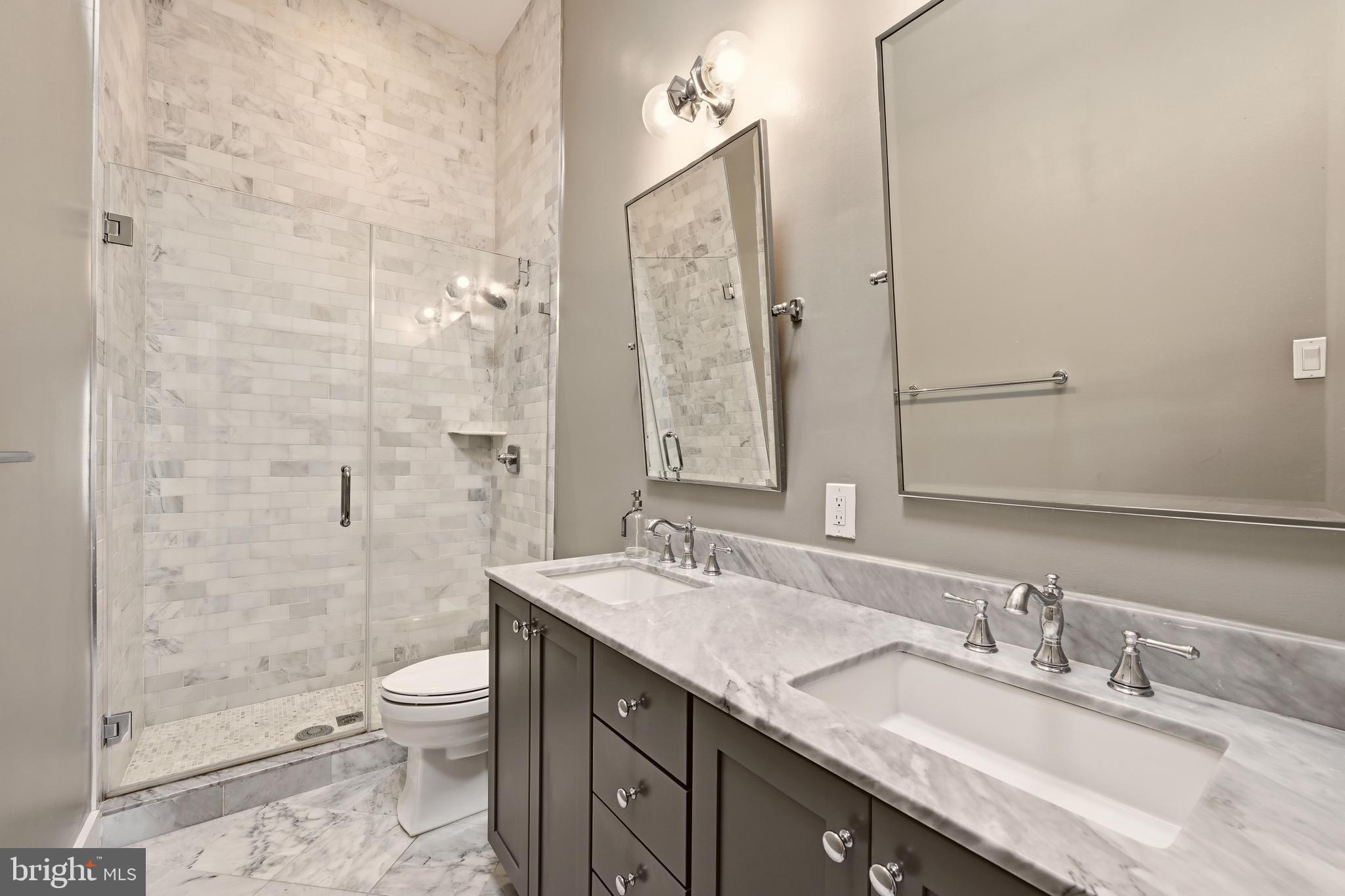 630 14th Street Northeast, Unit 5 Washington, DC 20002 - Photo 13 of 24 a bathroom with a granite countertop sink a toilet and shower