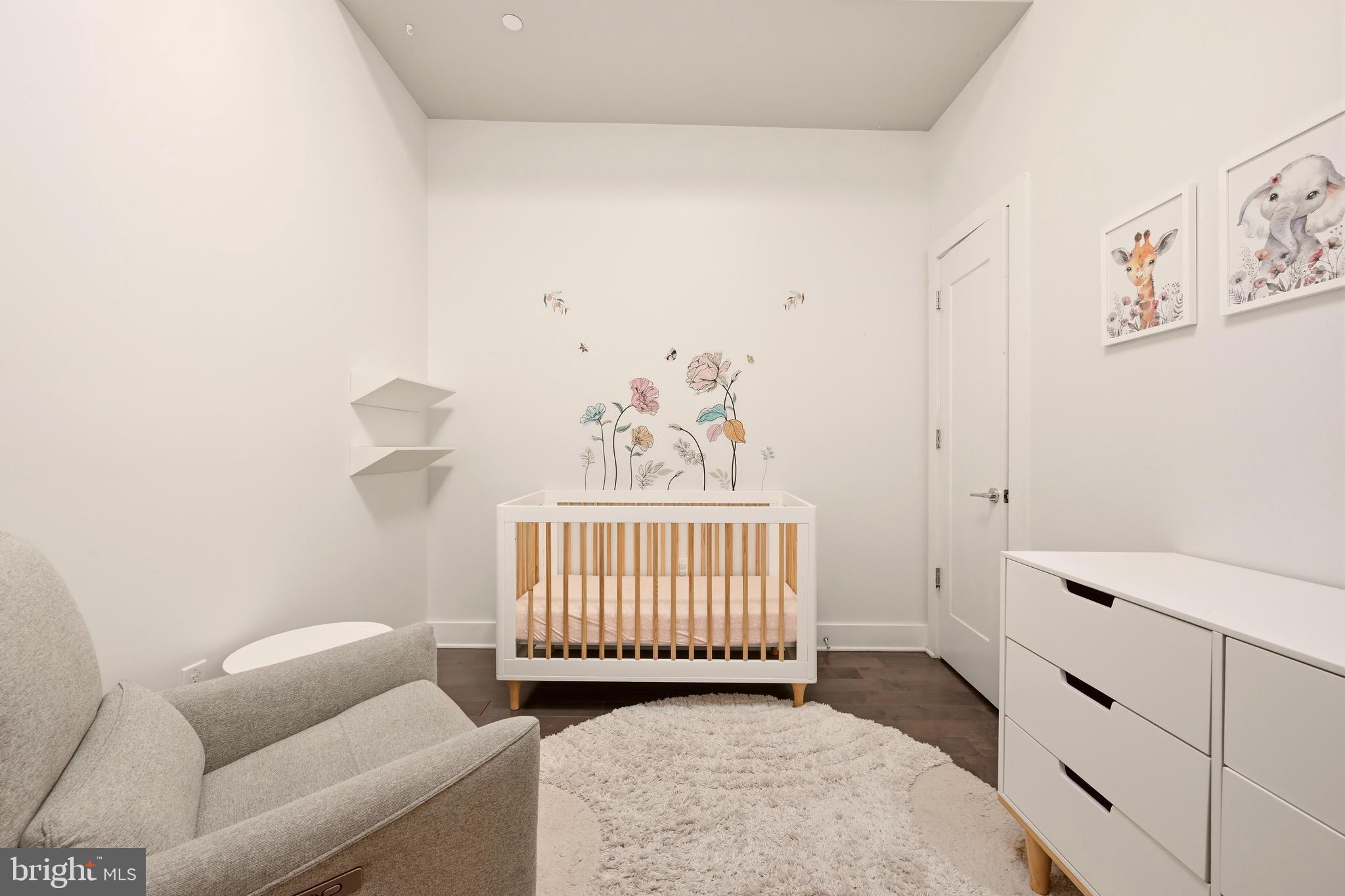 630 14th Street Northeast, Unit 5 Washington, DC 20002 - Photo 14 of 24 a bedroom with a baby bed a couch and a dresser
