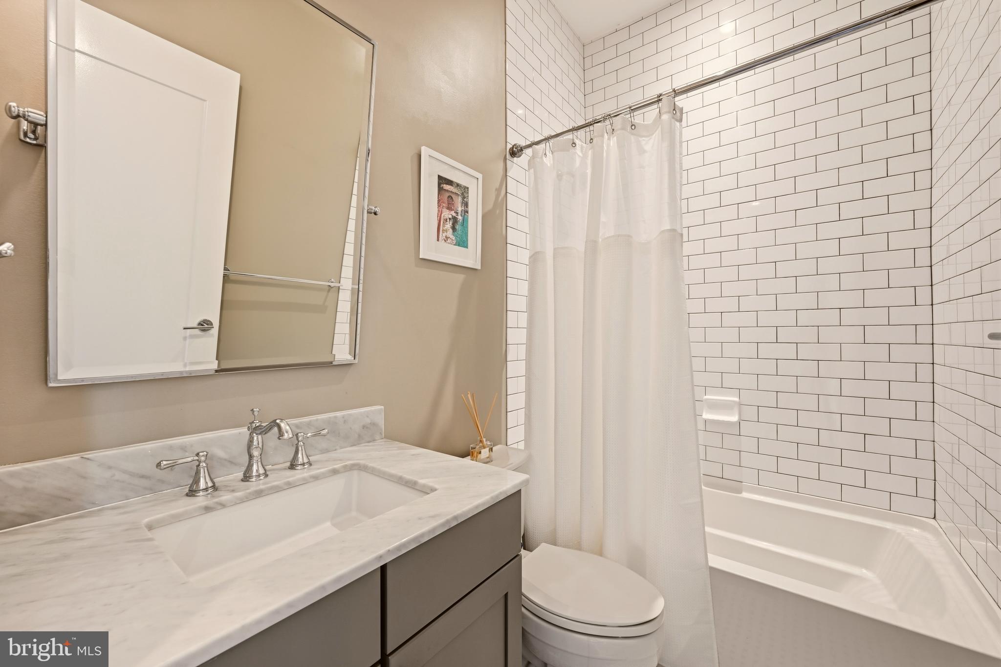 630 14th Street Northeast, Unit 5 Washington, DC 20002 - Photo 18 of 24 a bathroom with a granite countertop sink toilet and shower