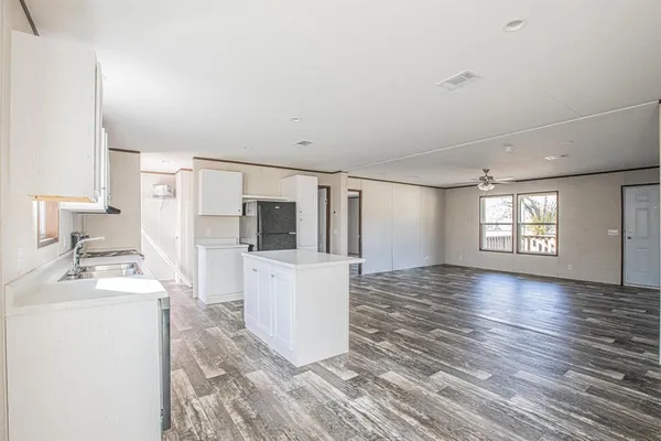 a view of a kitchen with a sink dishwasher and a refrigerator