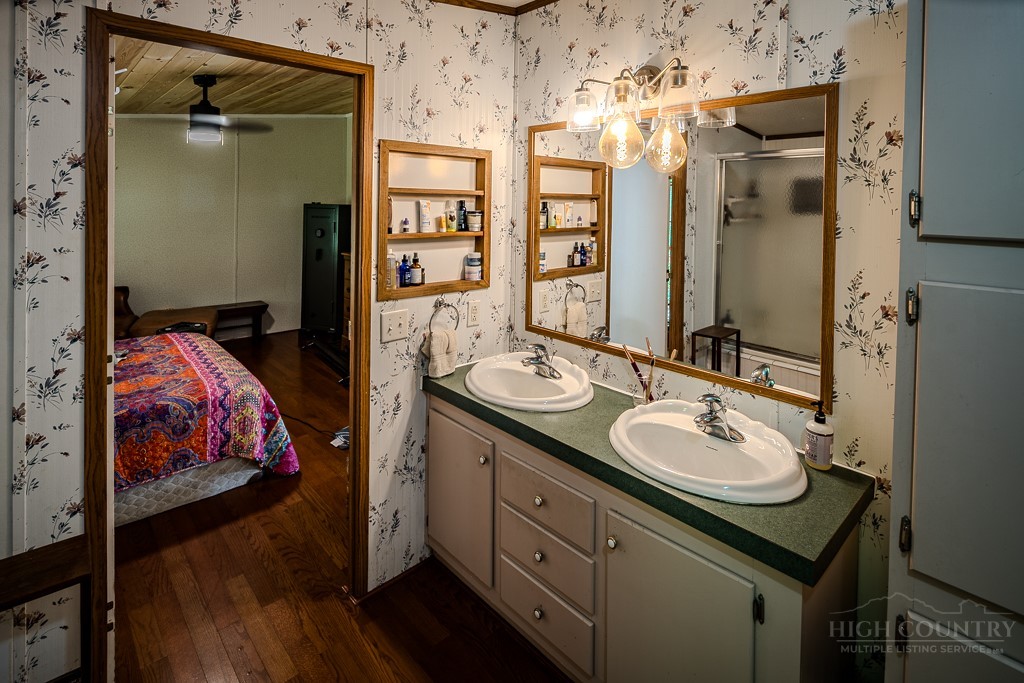 461 Reuben Wooten Road Banner Elk, NC 28604 - Photo 23 of 39 a en suite bathroom with a sink double vanity and a mirror