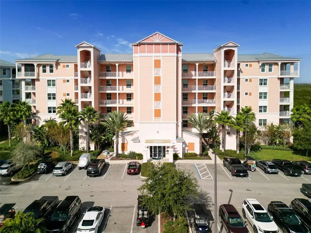 a front view of a building with glass windows and a yard