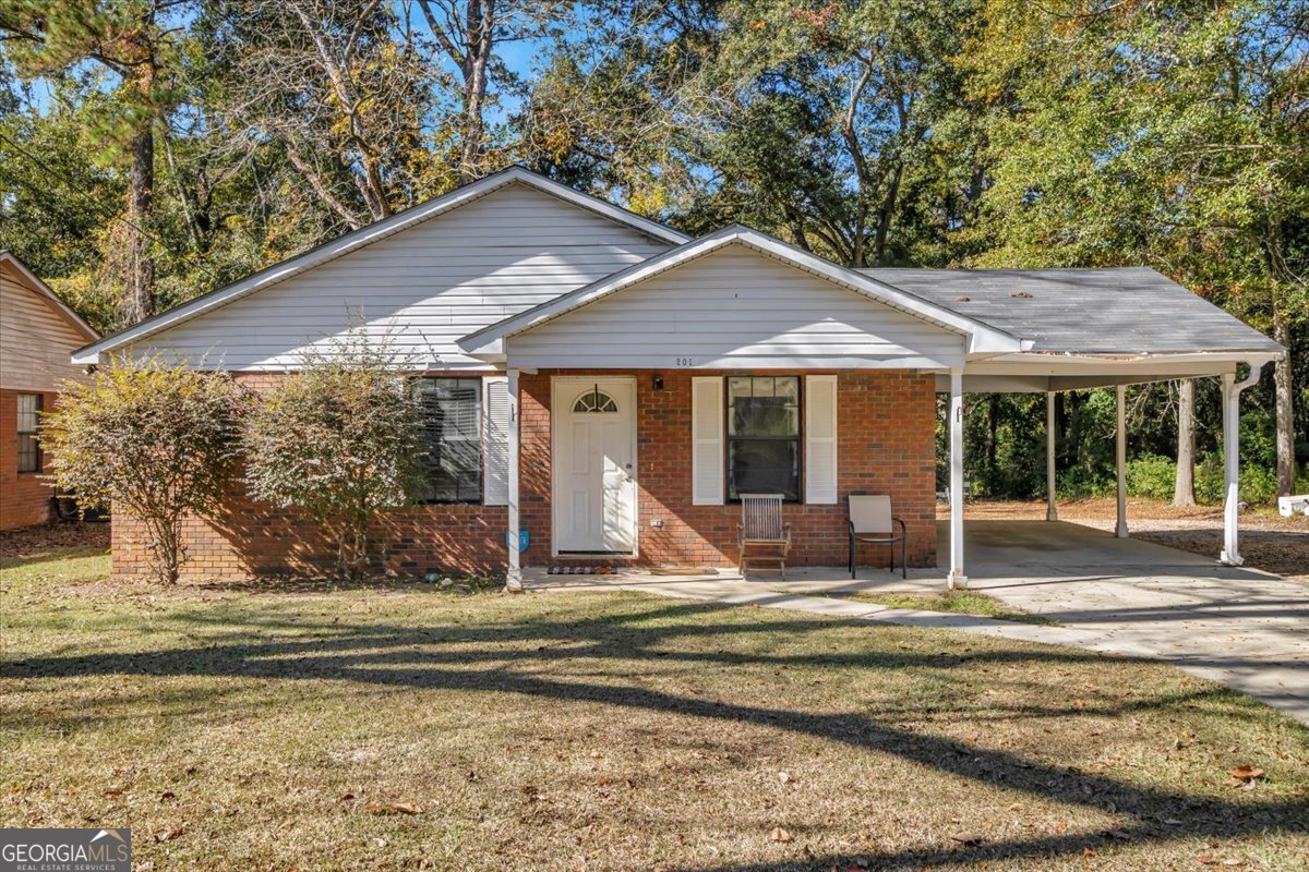 201 Culpepper Street Thomasville, GA 31792 - Photo 1 of 32 a view of a house with a yard patio and fire pit