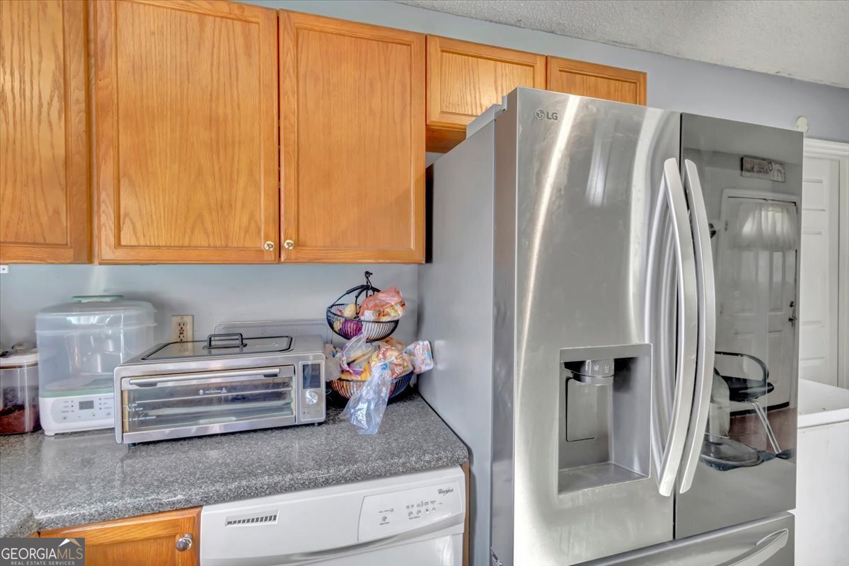 201 Culpepper Street Thomasville, GA 31792 - Photo 17 of 32 a kitchen with granite countertop a refrigerator and a sink