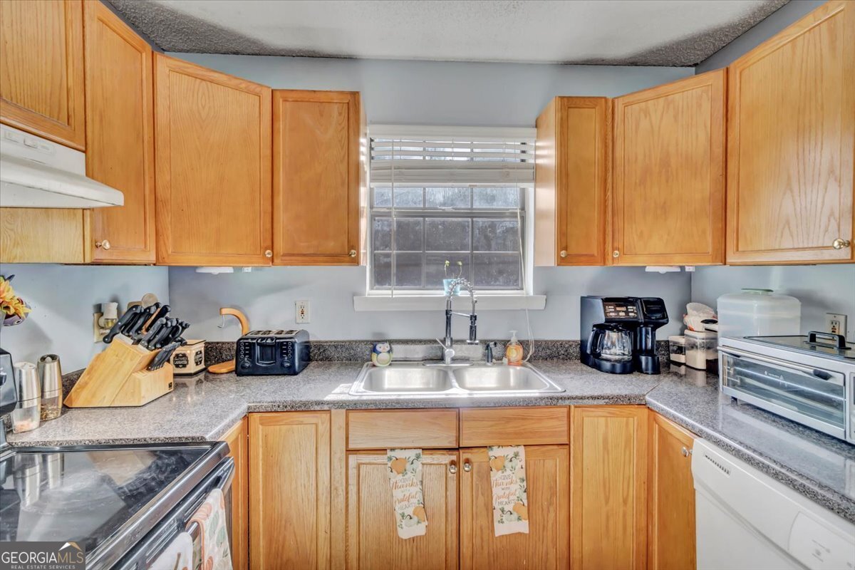 201 Culpepper Street Thomasville, GA 31792 - Photo 18 of 32 a kitchen with stainless steel appliances granite countertop sink stove and cabinets
