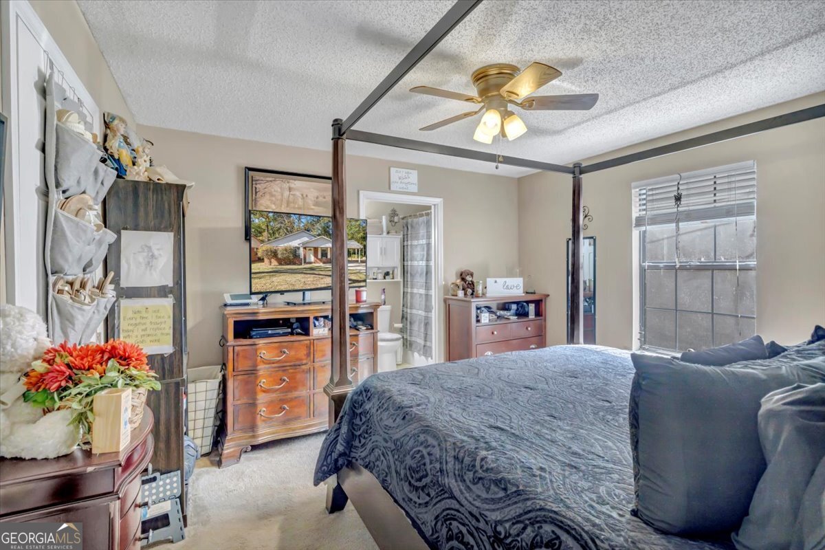201 Culpepper Street Thomasville, GA 31792 - Photo 2 of 32 a bedroom with a bed and a chandelier