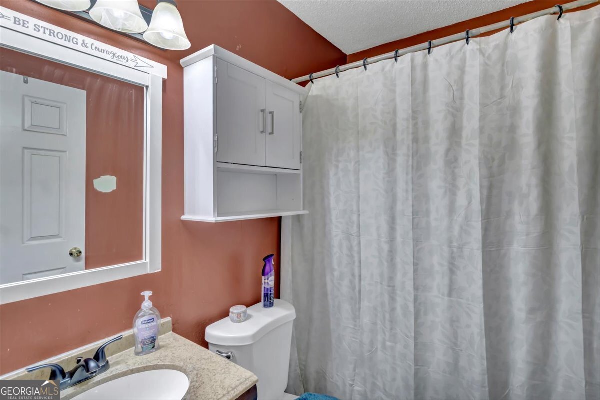 201 Culpepper Street Thomasville, GA 31792 - Photo 7 of 32 a bathroom with a sink mirror and toilet