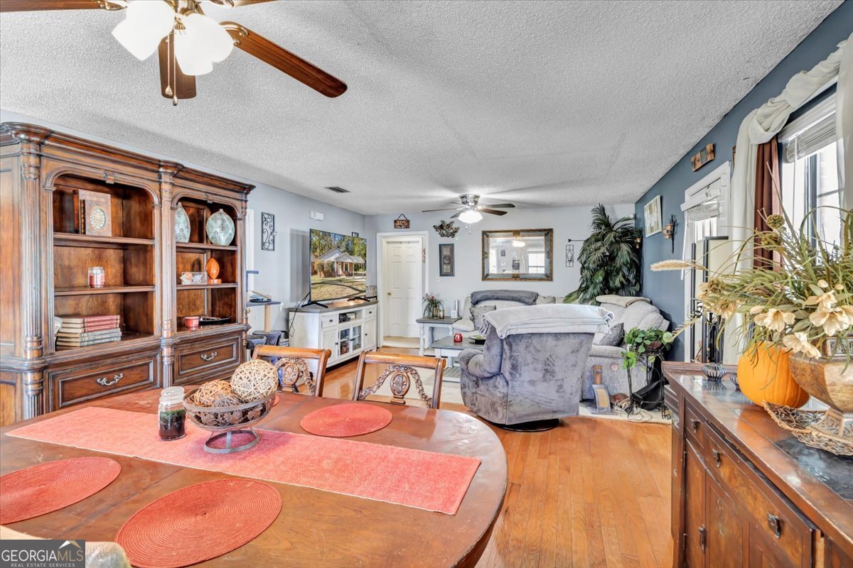201 Culpepper Street Thomasville, GA 31792 - Photo 10 of 32 a room with fireplace furniture and a wooden floor