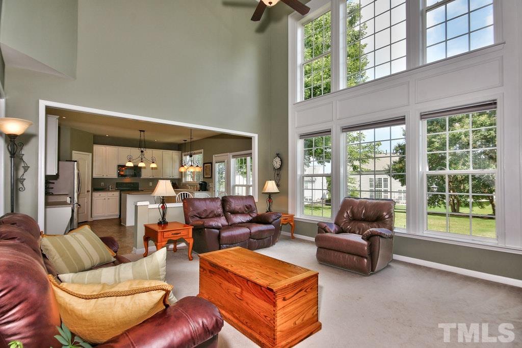 7624 Derek Drive Raleigh, NC 27613 - Photo 11 of 25 a living room with furniture and a large window