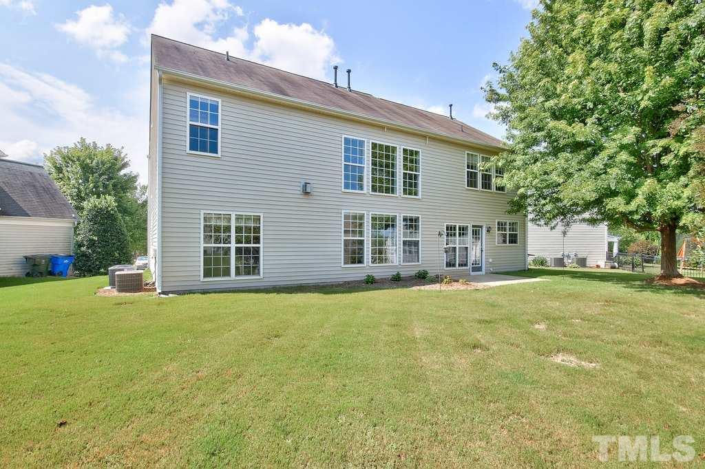 7624 Derek Drive Raleigh, NC 27613 - Photo 23 of 25 a view of a house with a yard and tree