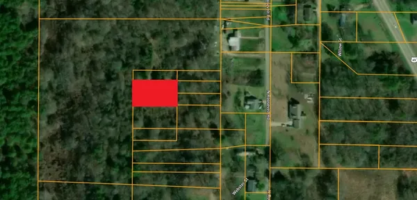 a view of a fence and house next to a yard