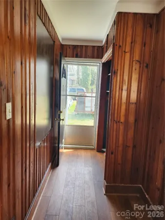 a view of entryway with wooden floor and door