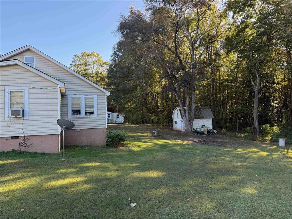 116 Young Street Buchanan, GA 30113 - Photo 4 of 5 a front view of house with yard and trees in the background