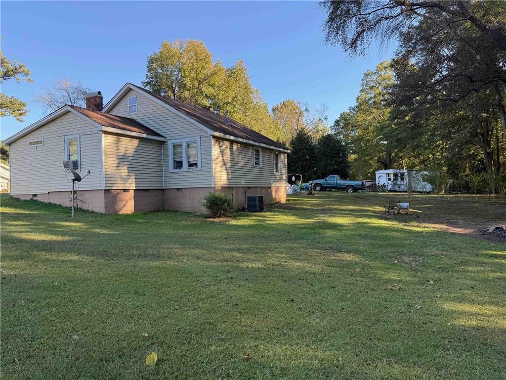 116 Young Street Buchanan, GA 30113 - Photo 5 of 5 a front view of house with yard and trees in the background