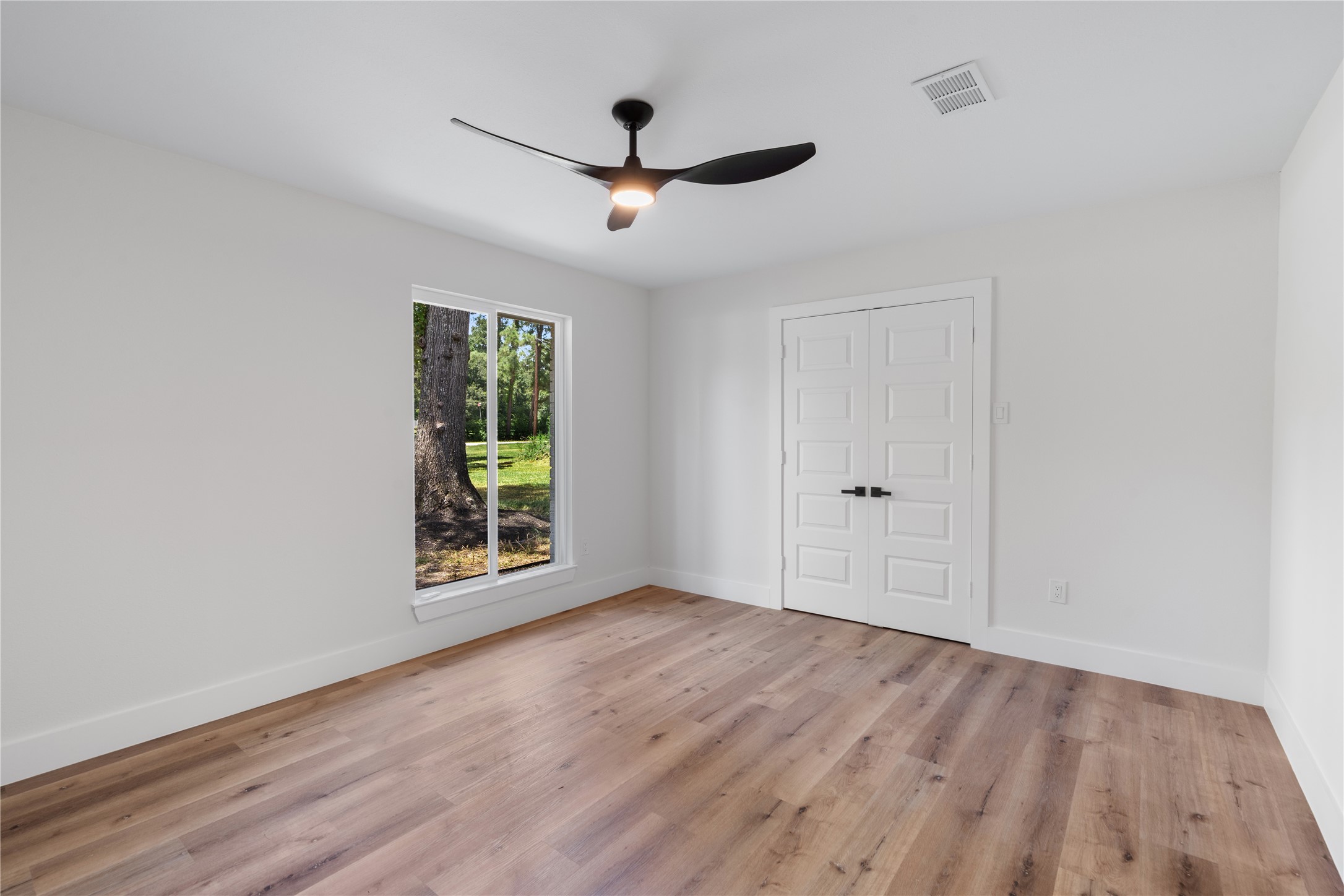 12019 Beth Lane Magnolia, TX 77354 - Photo 15 of 49 a view of an empty room with wooden floor and a window