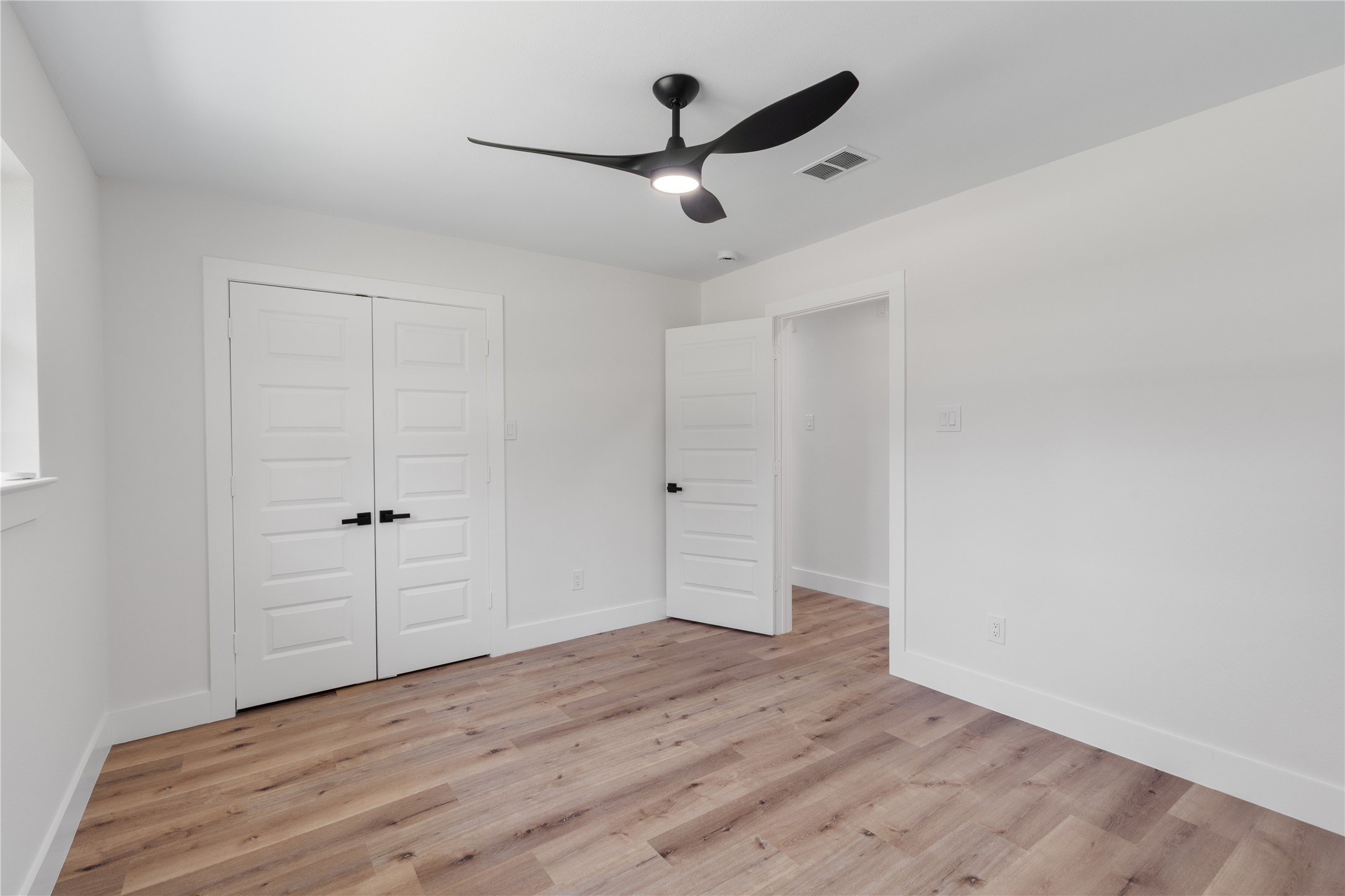 12019 Beth Lane Magnolia, TX 77354 - Photo 20 of 49 Spacious Bedroom 1- 5 panel doors, modern fan, no carpet.
