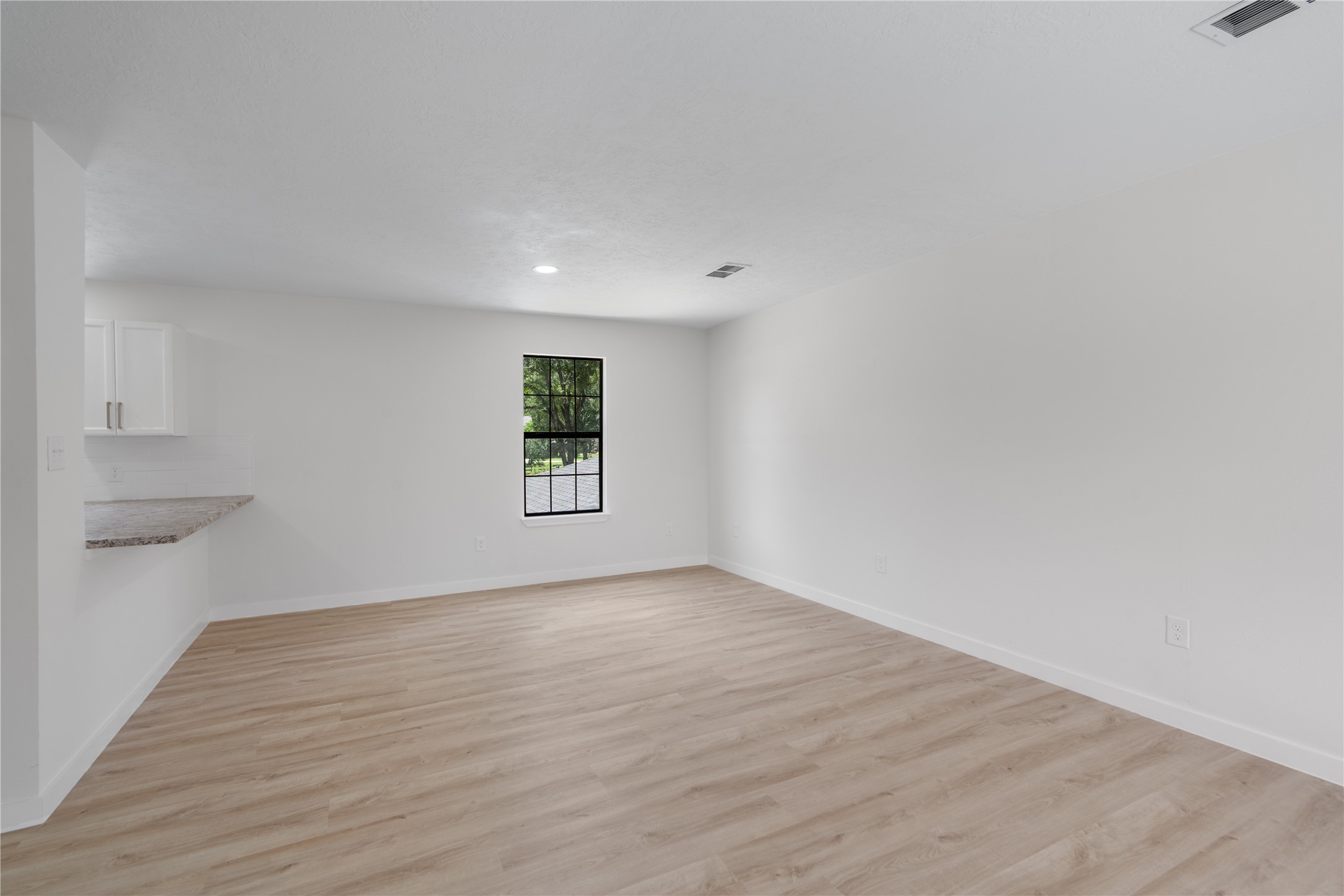 12019 Beth Lane Magnolia, TX 77354 - Photo 32 of 49 a view of an empty room with a window and wooden floor