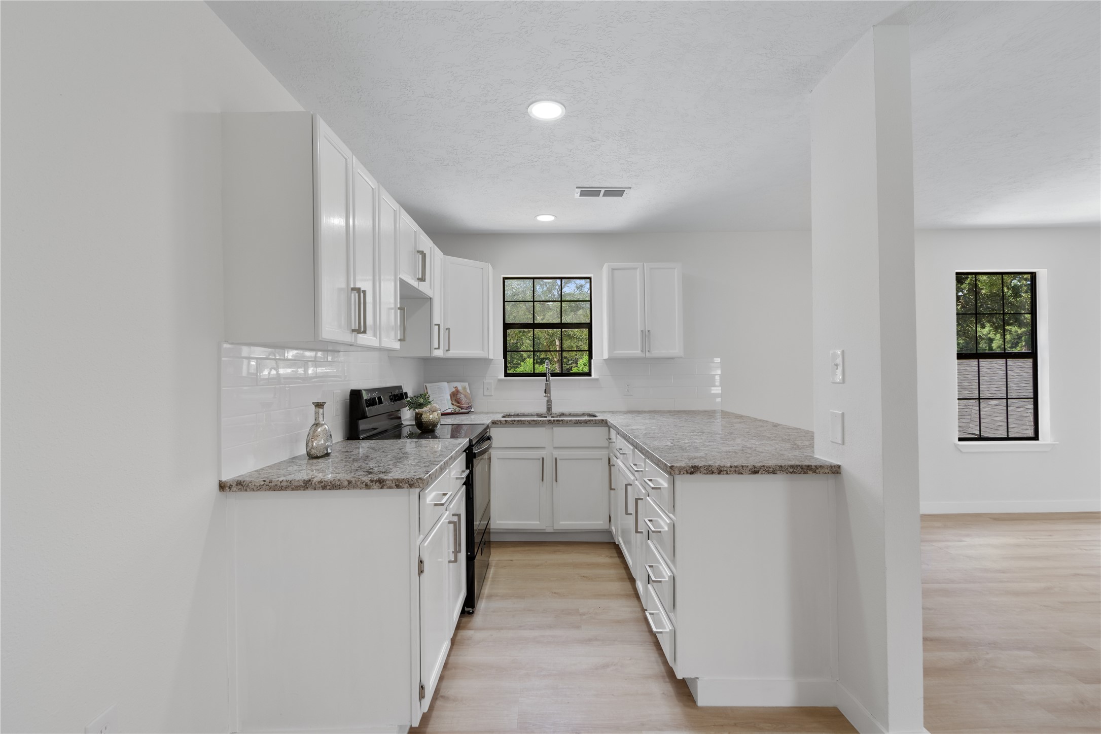 12019 Beth Lane Magnolia, TX 77354 - Photo 33 of 49 a kitchen with stainless steel appliances granite countertop a sink stove and cabinets