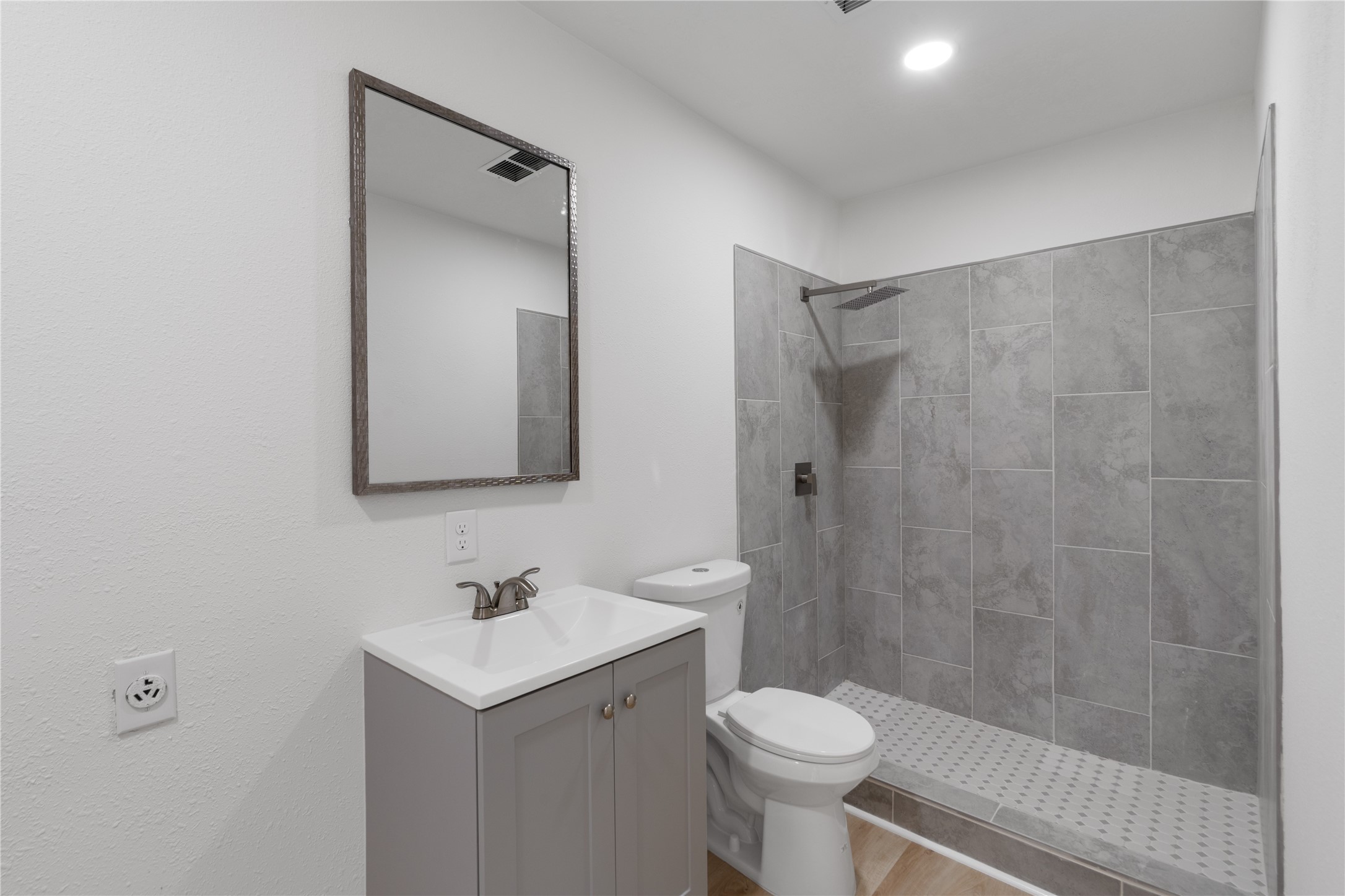 12019 Beth Lane Magnolia, TX 77354 - Photo 36 of 49 a bathroom with a sink toilet a mirror and shower