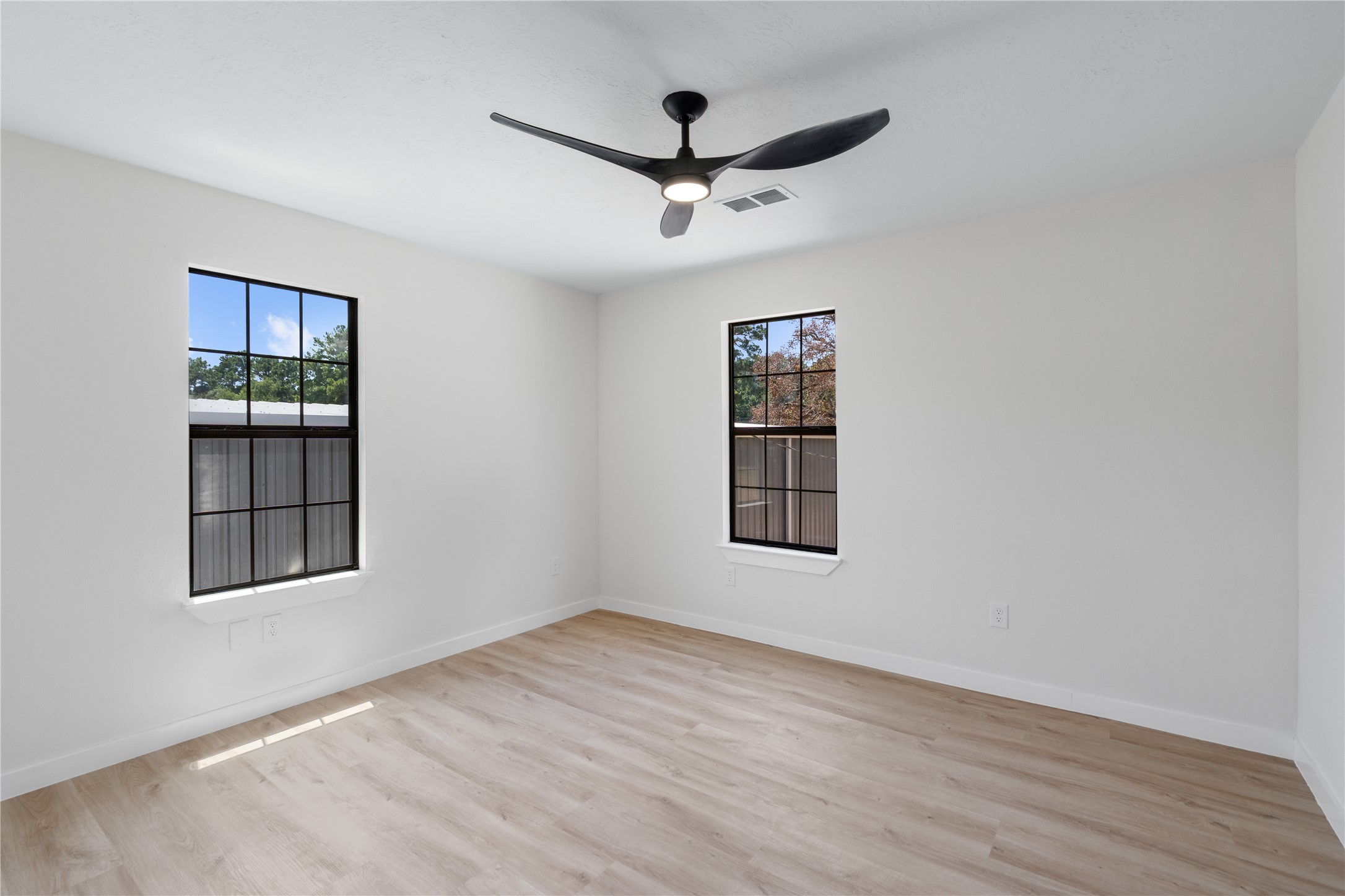 12019 Beth Lane Magnolia, TX 77354 - Photo 37 of 49 a view of an empty room with a window and wooden floor