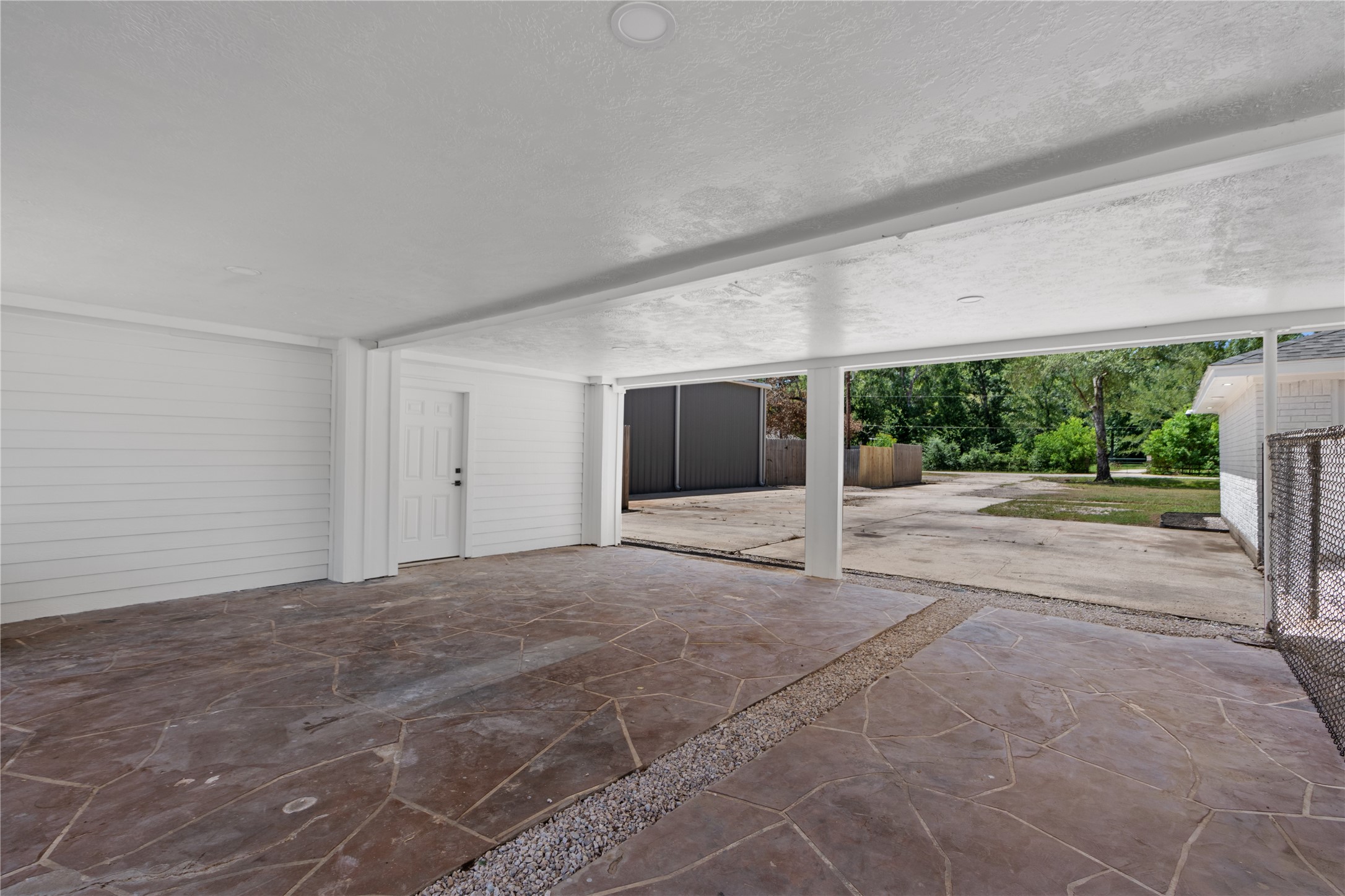 12019 Beth Lane Magnolia, TX 77354 - Photo 41 of 49 Lots of Parking Options- Including this Covered carport with Led lighting, Stamped Concrete, and even a 250 SF storage area with 1/2 Bath for quick outside access of make it the workshop bath! Plumbed for shower install.