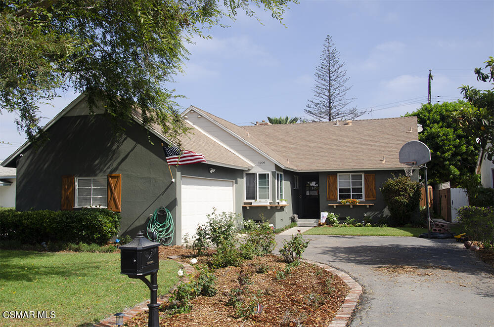1209 West Roderick Avenue Oxnard, CA 93030 - Photo 1 of 30 a front view of house with a garden