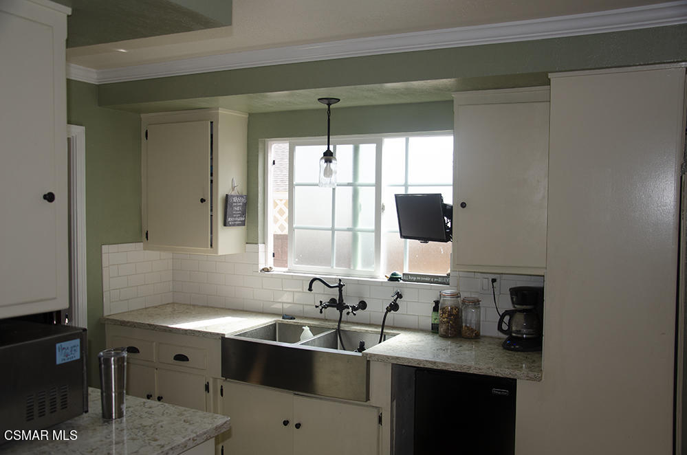 1209 West Roderick Avenue Oxnard, CA 93030 - Photo 14 of 30 a kitchen with a sink stove and cabinets