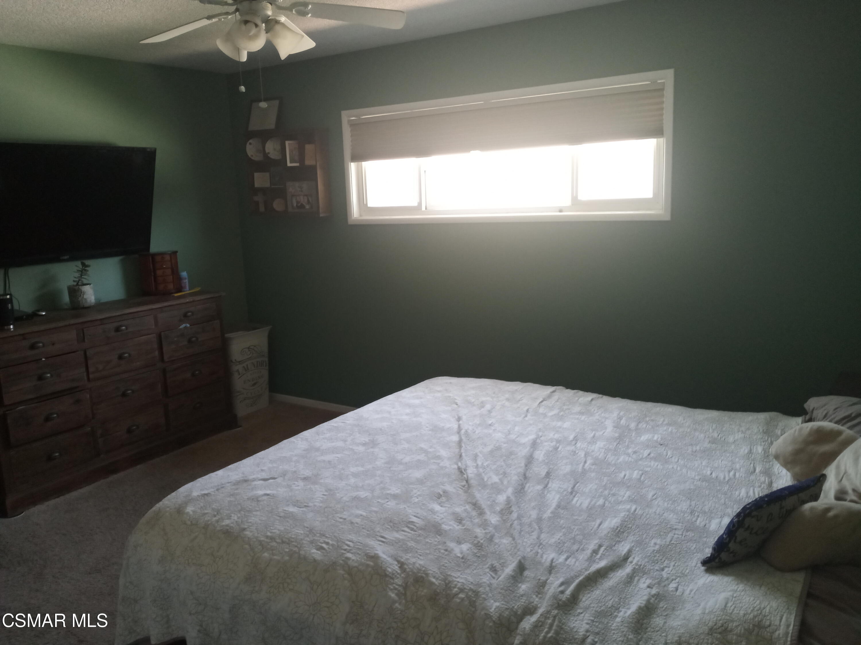1209 West Roderick Avenue Oxnard, CA 93030 - Photo 24 of 30 a bedroom with a bed and a flat tv screen on dresser