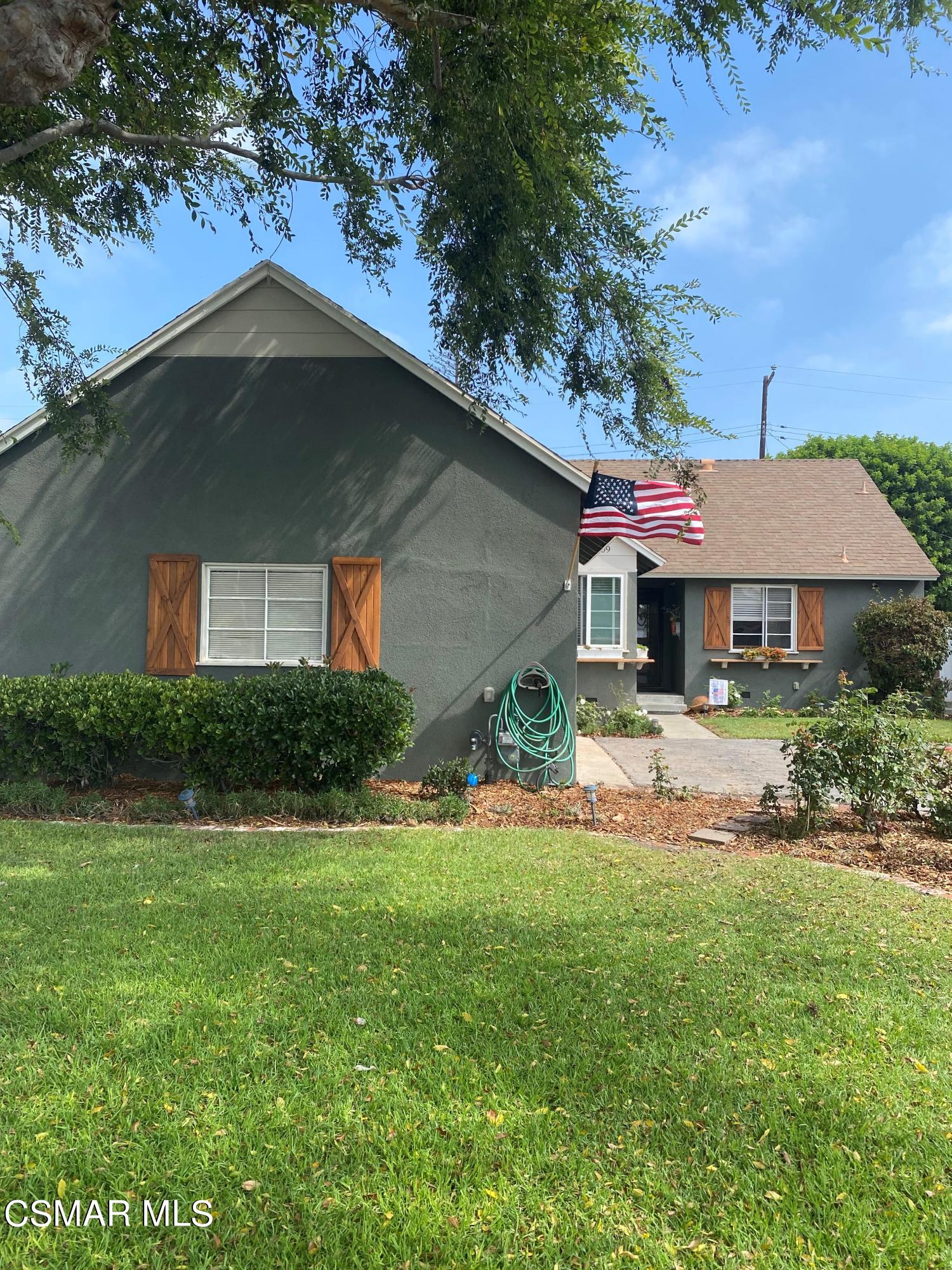 1209 West Roderick Avenue Oxnard, CA 93030 - Photo 4 of 30 a front view of a house with a yard