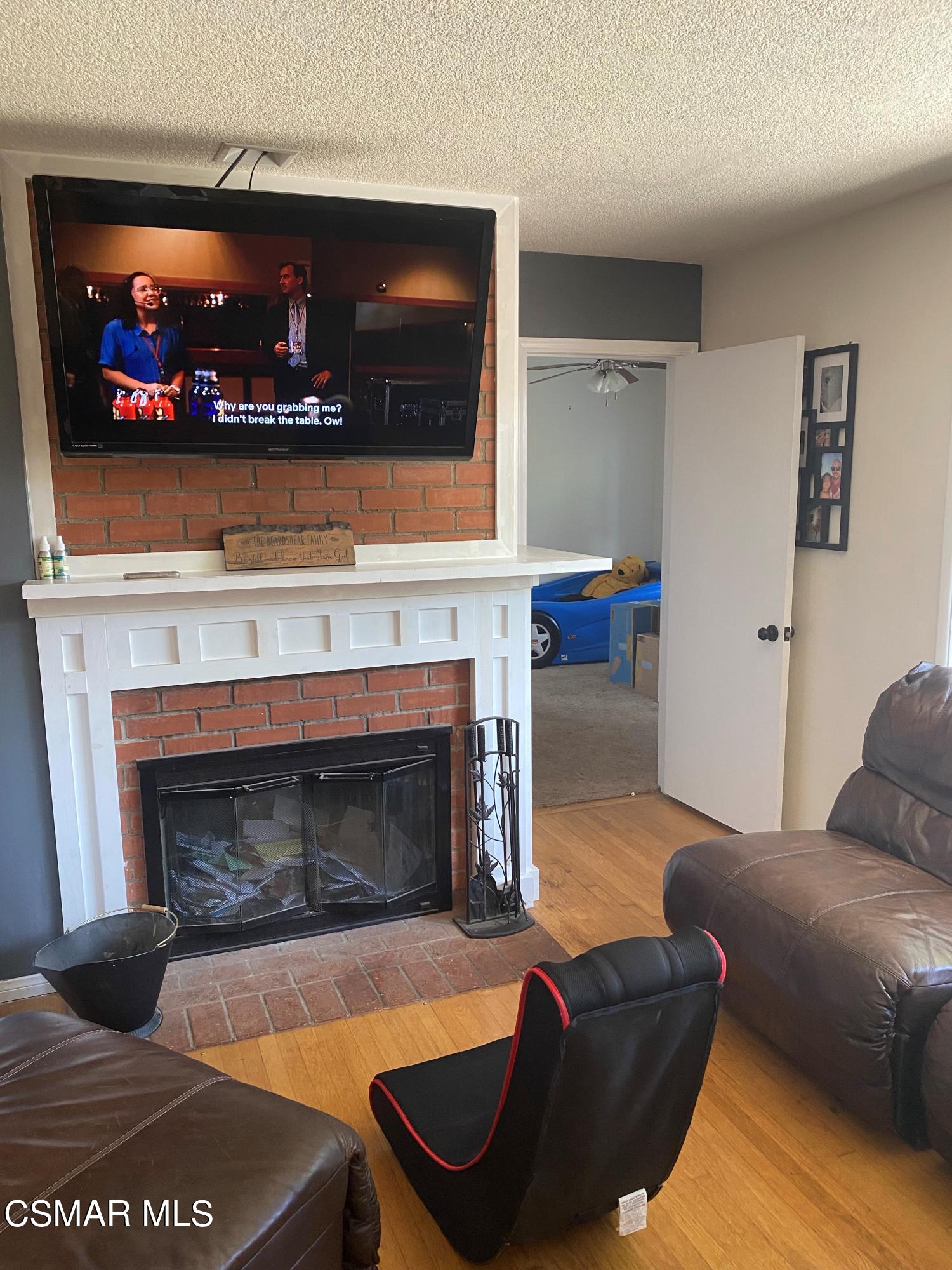 1209 West Roderick Avenue Oxnard, CA 93030 - Photo 7 of 30 a living room with furniture a flat screen tv and a fireplace
