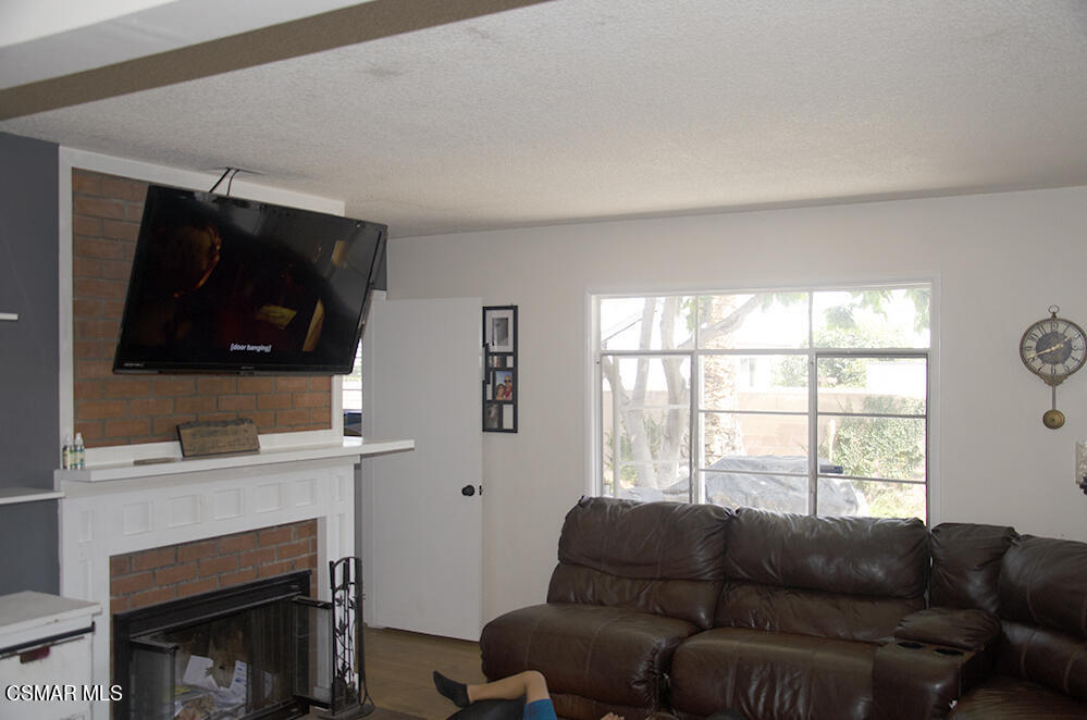1209 West Roderick Avenue Oxnard, CA 93030 - Photo 8 of 30 a living room with furniture a flat screen tv and a window