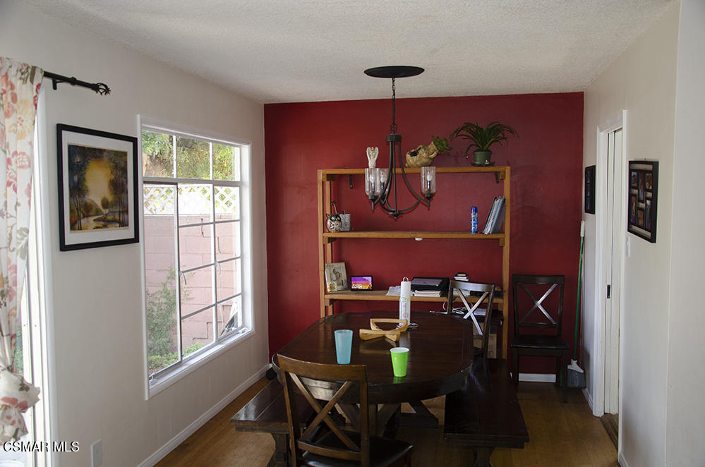 1209 West Roderick Avenue Oxnard, CA 93030 - Photo 9 of 30 a view of a dining room with furniture window and wooden floor