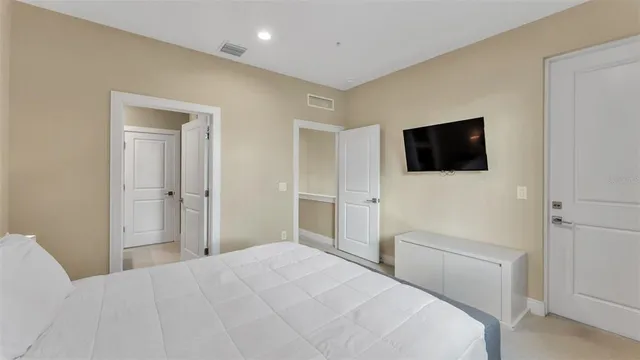 a bedroom with two beds and a large mirror