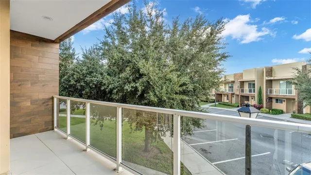 a view of a house with a yard and large tree and plants