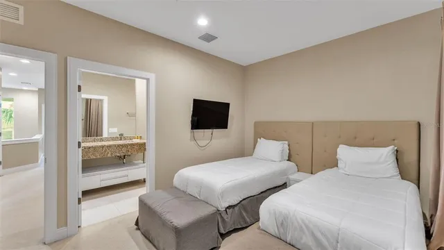 a view of a swimming pool with a lawn chairs under palm trees