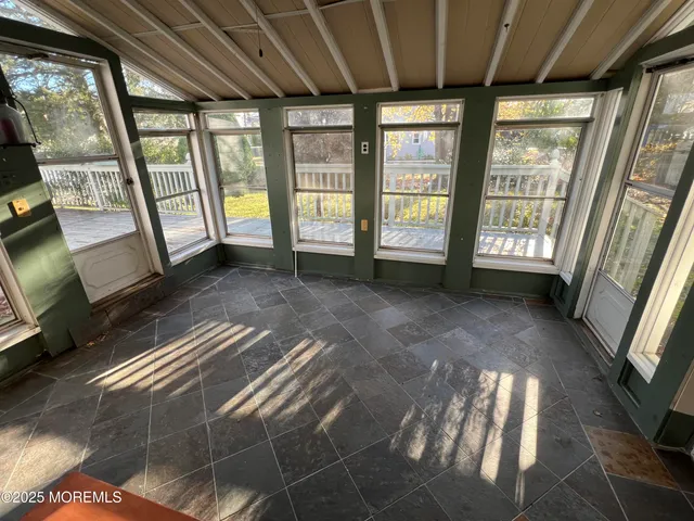 a view of an empty room with a fireplace and a window