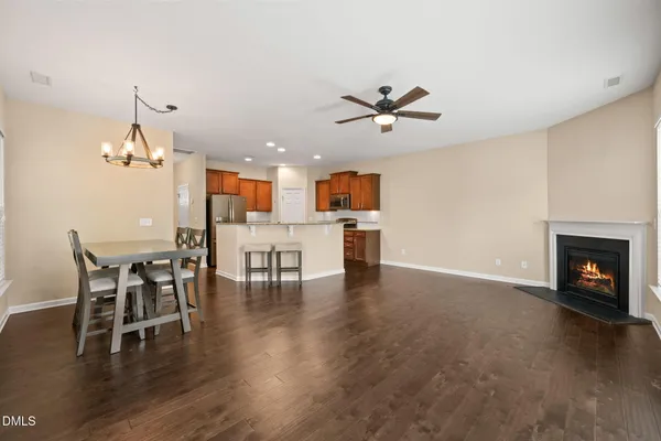 a view of a dining room with furniture wooden floor and a fireplace