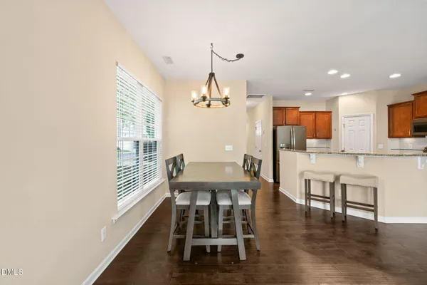 a view of a dining room with furniture and wooden floor