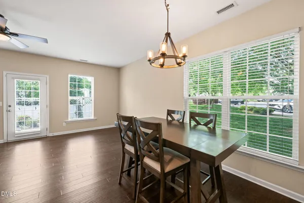 a view of a dining room with furniture window and wooden floor