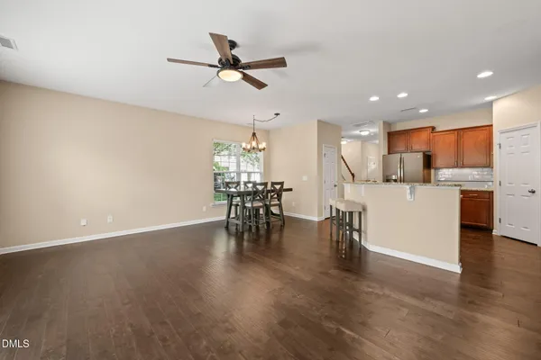 a view of a kitchen with wooden floor and a window
