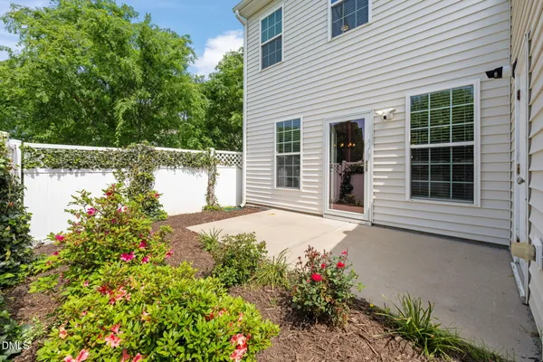 a house with a yard and flowers in front of it
