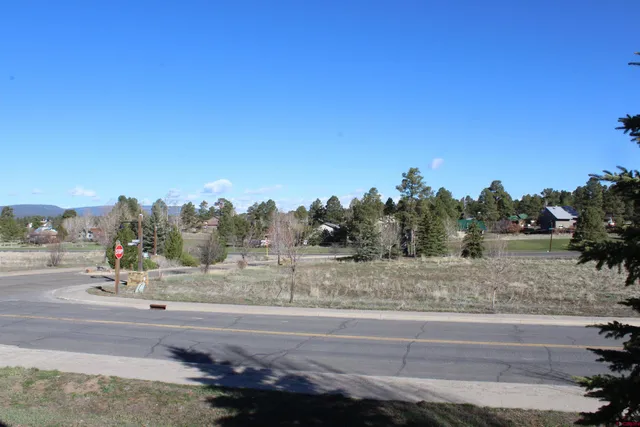 a view of a road with a building in the background