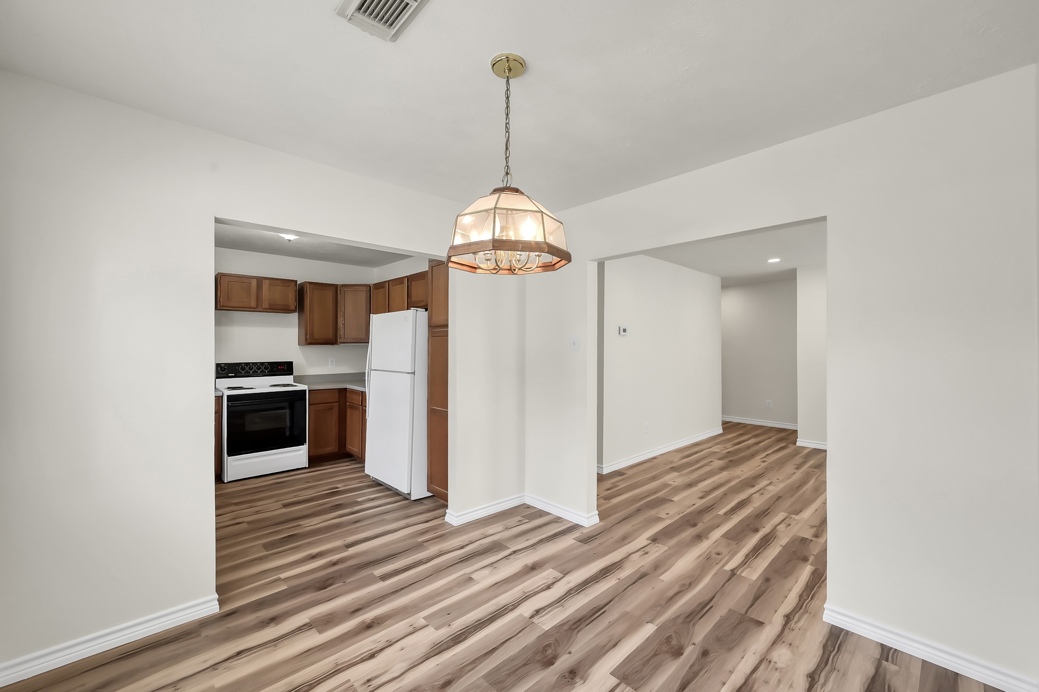 6 Hollow Forest Trinity, TX 75862 - Photo 22 of 38 a view of a kitchen with a refrigerator a stove top oven and kitchen view