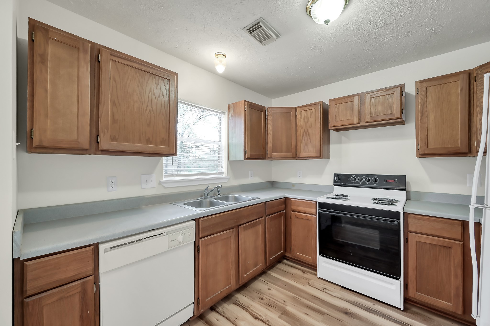 6 Hollow Forest Trinity, TX 75862 - Photo 24 of 38 a kitchen with a sink stove top oven and cabinets