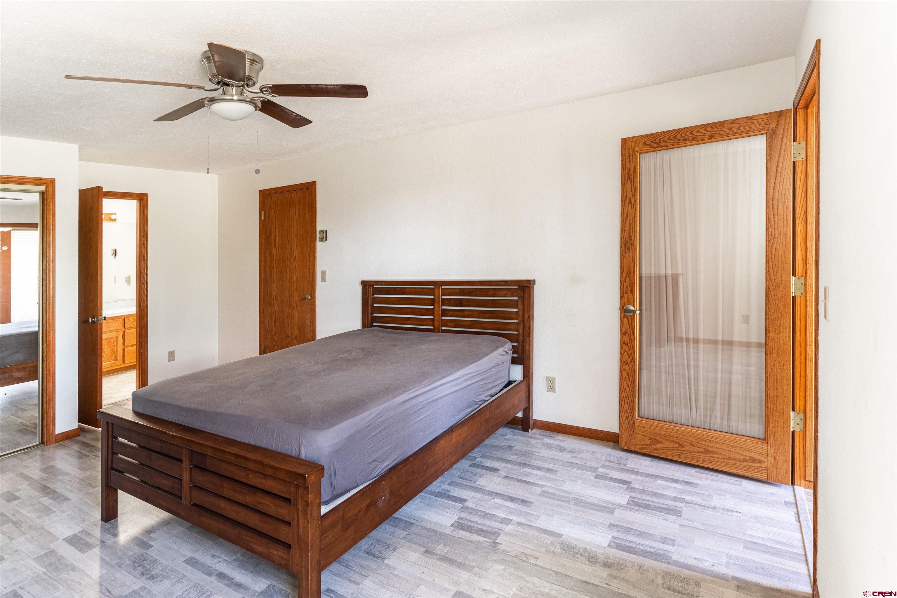 3754 2000th Road Delta, CO 81416 - Photo 23 of 35 a bedroom with a bed and a chandelier