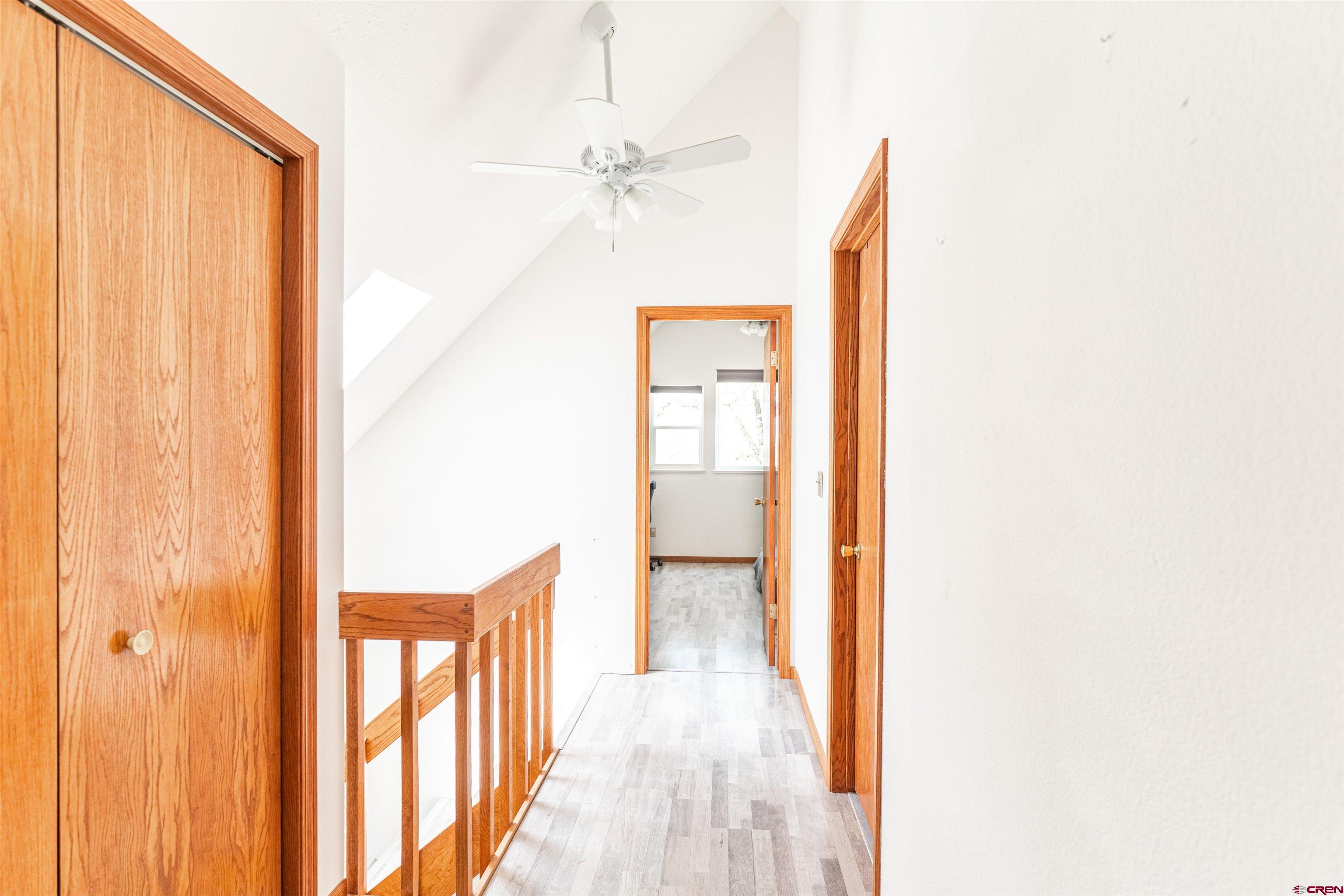 3754 2000th Road Delta, CO 81416 - Photo 29 of 35 a view of a hallway with wooden floor and a bathroom