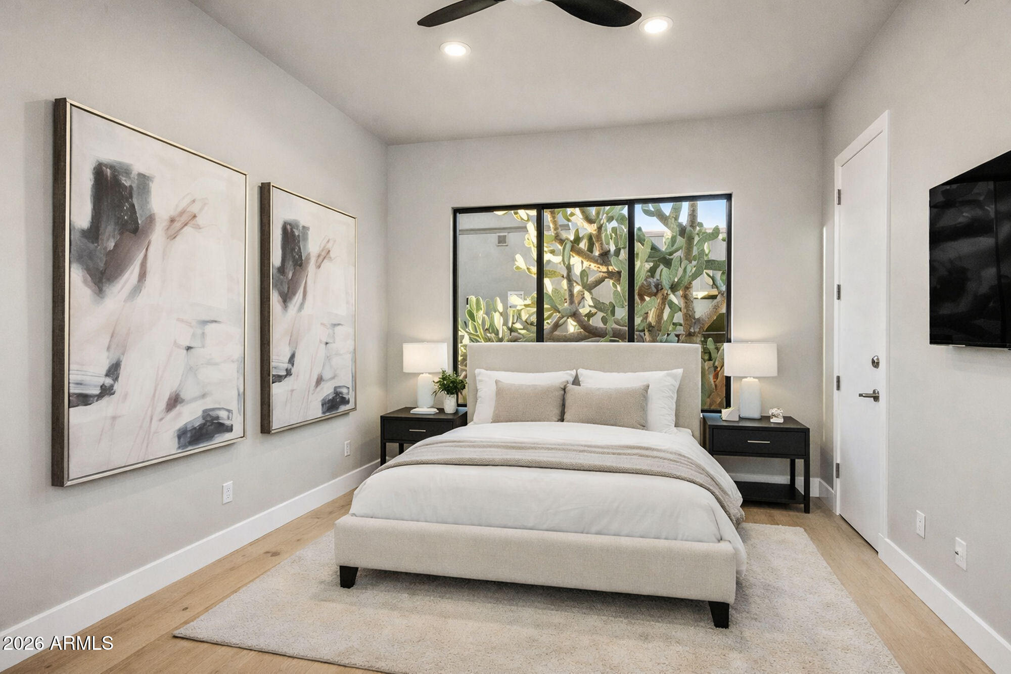 11083 East Juan Tabo Road Scottsdale, AZ 85255 - Photo 23 of 46 a bedroom with a bed and a flat tv screen on dresser