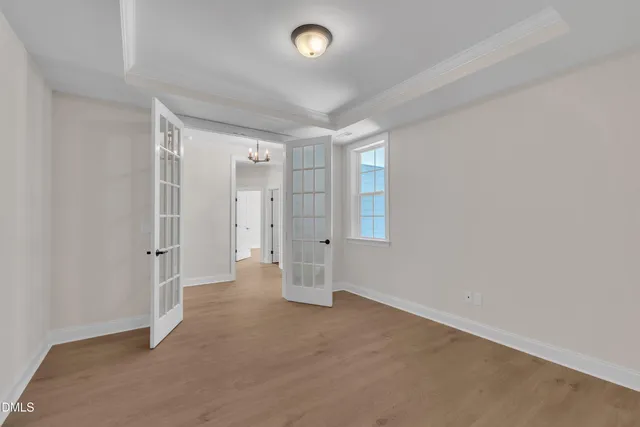 an empty room with a cabinet and mirrors