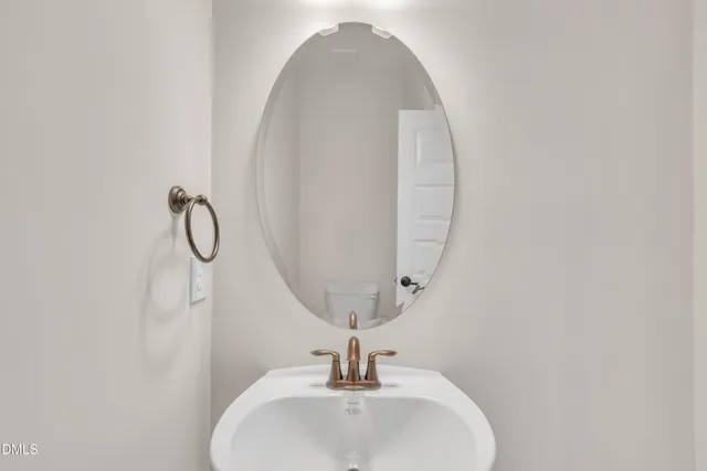 a bathroom with a sink and mirror
