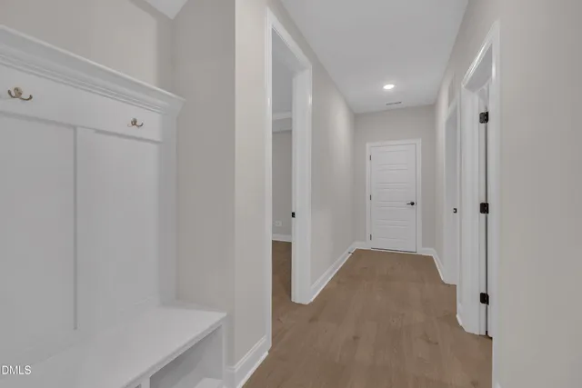a view of a hallway with wooden floor